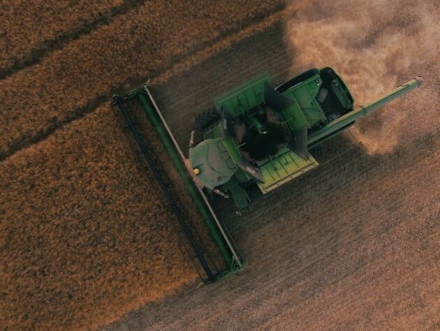 An aerial view of a tractor in a field.