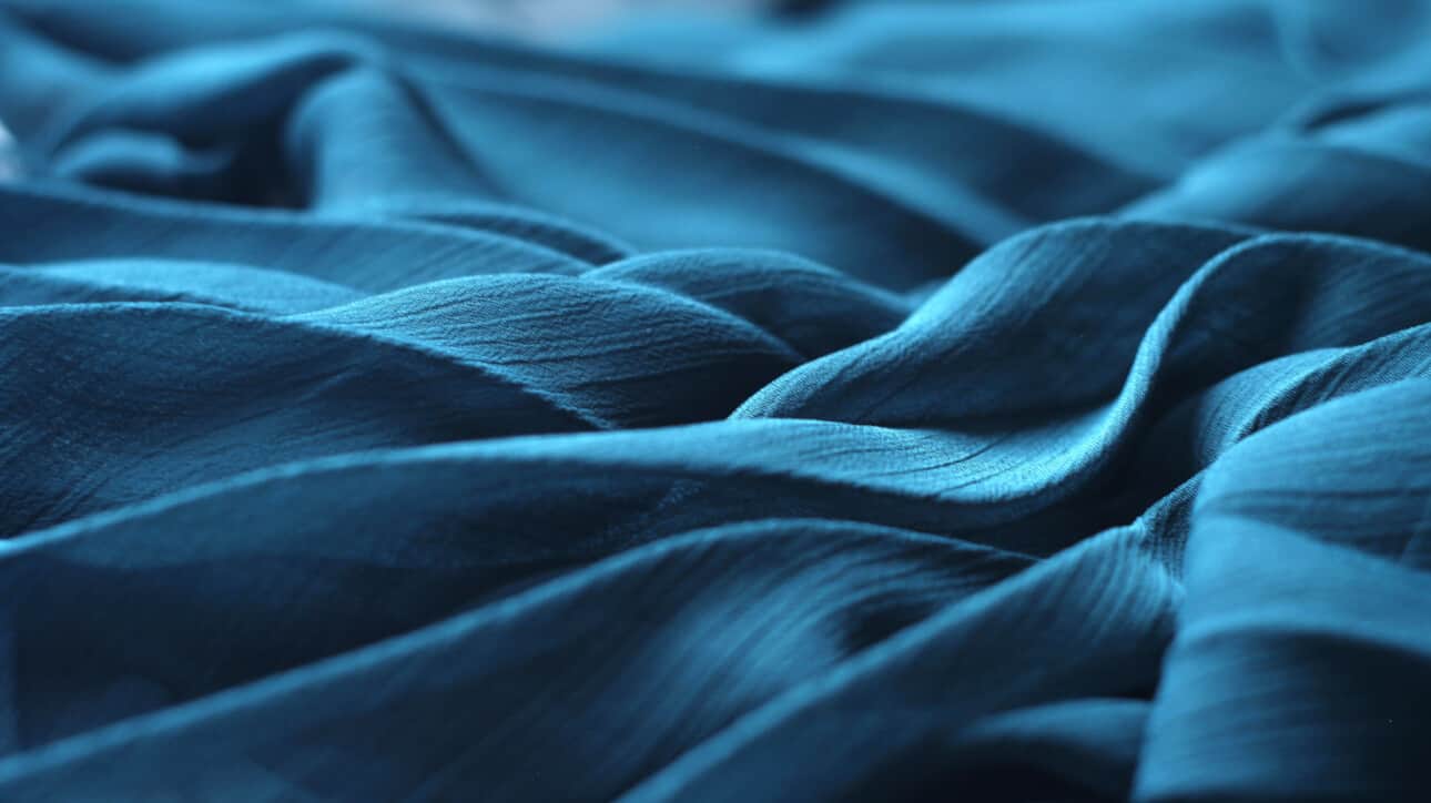 blue fabric with folds and ripples.